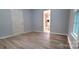 An airy bedroom with wood-look floors leads into an ensuite bathroom with a glass shower at 155 31St Sw St, Hickory, NC 28602