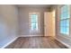 A bedroom with wood-look flooring, neutral-colored walls, and two large windows for lots of natural light at 155 31St Sw St, Hickory, NC 28602