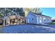 Rear exterior view of the home with a car port and spacious gravel driveway at 155 31St Sw St, Hickory, NC 28602