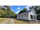 Side exterior view of the house showing windows, gray siding, and trimmed shrubs at 155 31St Sw St, Hickory, NC 28602