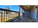 Covered front porch with a wood ceiling and floor, black railings, and bright, natural light at 155 31St Sw St, Hickory, NC 28602