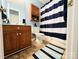 Cozy bathroom features wood cabinets, blue walls, and a striped shower curtain at 1743 Park Grove Nw Pl, Concord, NC 28027