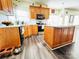 Well-lit kitchen featuring stainless steel appliances, warm oak cabinets and an island with white countertops at 1743 Park Grove Nw Pl, Concord, NC 28027