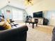 Inviting living room with a ceiling fan, blue walls, neutral carpet, and comfortable seating area at 1743 Park Grove Nw Pl, Concord, NC 28027