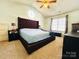 Inviting primary bedroom featuring a large bed, vaulted ceiling, and a circular window for natural light at 1743 Park Grove Nw Pl, Concord, NC 28027