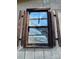 Close up of a window with tattered shutters and boarded up at 185 Flat Stone Dr, Clover, SC 29710