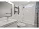 This bathroom features a shower-tub combo with subway tile, a dark framed mirror, and a sink vanity, with a clean design at 18948 Kanawha Dr, Cornelius, NC 28031