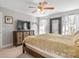 Comfortable bedroom with a large bed, ceiling fan, neutral walls, and ensuite access at 18948 Kanawha Dr, Cornelius, NC 28031