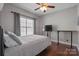 This bedroom features hardwood floors, a ceiling fan, and a large window with natural light, with a modern design at 18948 Kanawha Dr, Cornelius, NC 28031