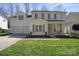 Charming two-story home with a well-manicured lawn, attached two car garage and inviting front porch at 18948 Kanawha Dr, Cornelius, NC 28031