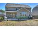 Exterior rear view showcasing a patio with green chairs and a grill at 2025 Sweet Magnolia Ln, Clover, SC 29710