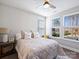 Sunlit bedroom featuring large windows, a ceiling fan, and plush decor, creating a warm and inviting atmosphere at 2025 Sweet Magnolia Ln, Clover, SC 29710