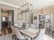 Bright and airy dining room with modern chandelier and hardwood floors throughout at 2025 Sweet Magnolia Ln, Clover, SC 29710