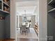 Dining room with a stylish light fixture, large window, and modern decor as seen from the entryway at 2025 Sweet Magnolia Ln, Clover, SC 29710