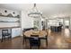 Dining area showcases a round table with seating, built-in shelving, and hardwood floors, with access to the kitchen at 2025 Sweet Magnolia Ln, Clover, SC 29710