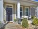 Cozy front porch features rocking chairs, a welcome sign, and decorative plants at 2025 Sweet Magnolia Ln, Clover, SC 29710