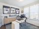 Bright home office with modern desk, ergonomic chair, and hockey sports memorabilia at 2025 Sweet Magnolia Ln, Clover, SC 29710