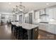 Modern kitchen features a large island with pendant lighting, barstool seating and stainless steel appliances at 2025 Sweet Magnolia Ln, Clover, SC 29710