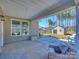 Covered patio with view of backyard featuring lush trees, play structure and storage shed at 2025 Sweet Magnolia Ln, Clover, SC 29710