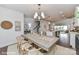 Open-concept dining room with a modern chandelier, dining table, and adjacent kitchen and living spaces at 208 Wesser St # 8, Davidson, NC 28036