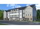 A view of newly constructed townhomes showcasing different facade designs and brick accents at 208 Wesser St # 8, Davidson, NC 28036