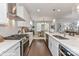 Modern kitchen with stainless steel appliances, white cabinets, and an island overlooking the dining area at 208 Wesser St # 8, Davidson, NC 28036