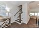 Hallway featuring a staircase with wood railings and views into the living room at 208 Wesser St # 8, Davidson, NC 28036