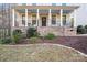 Inviting home exterior featuring a stone-accented front porch, manicured landscaping, and a well-maintained lawn at 220 Kenway Loop # 41, Mooresville, NC 28117