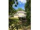 View of back of home with deck and siding through trees at 220 Kenway Loop, Mooresville, NC 28117