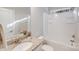Bathroom with vanity and white tub/shower combo, featuring good natural light at 220 Kenway Loop, Mooresville, NC 28117