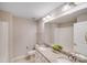 Well-lit bathroom features a double vanity with granite countertop, white cabinetry, and a large mirror at 220 Kenway Loop, Mooresville, NC 28117
