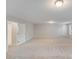 A spacious, freshly painted bonus room with neutral walls and plush carpeting awaits your creative touch at 220 Kenway Loop, Mooresville, NC 28117