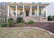 Charming front porch featuring stone accents, decorative railings, and cozy seating, enhancing the home's curb appeal at 220 Kenway Loop, Mooresville, NC 28117