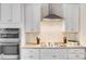 Modern kitchen with stainless steel appliances, granite counters, tile backsplash and white cabinets at 220 Kenway Loop, Mooresville, NC 28117