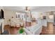 Spacious living room with hardwood floors, ceiling fan, and views into dining and kitchen at 220 Kenway Loop, Mooresville, NC 28117