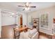 Bright living room with modern ceiling fan, desk, chair, hardwood floors and lots of natural light at 220 Kenway Loop, Mooresville, NC 28117