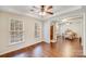 Bright and airy living room with hardwood floors and views through large windows at 220 Kenway Loop, Mooresville, NC 28117