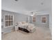 Spacious main bedroom with sitting area and multiple windows for plenty of natural light at 220 Kenway Loop, Mooresville, NC 28117
