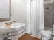 Bathroom featuring a pedestal sink, classic fixtures, and tiled shower at 2338 Yadkin Ave # 503, Charlotte, NC 28205