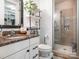 Well-lit bathroom featuring a vanity with granite countertop and a glass-enclosed shower at 2338 Yadkin Ave # 503, Charlotte, NC 28205