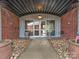 Building entrance featuring brickwork, glass doors, and landscaped entryway at 2338 Yadkin Ave # 503, Charlotte, NC 28205