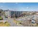 A view of the exterior of the building, nearby parking and neighboring cityscape on a bright sunny day at 2338 Yadkin Ave # 503, Charlotte, NC 28205