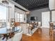 Bright open-plan living area with industrial ceiling, dining space and a large window at 2338 Yadkin Ave # 503, Charlotte, NC 28205