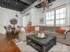 Stylish living room with a large sectional sofa, exposed ductwork, and a modern light fixture at 2338 Yadkin Ave # 503, Charlotte, NC 28205