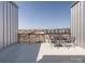 Outdoor patio with black metal table and seating with a view of the parking lot and neighboring buildings at 2338 Yadkin Ave # 503, Charlotte, NC 28205