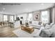 Open-concept living room with hardwood floors, neutral decor, and abundant natural light at 2528 Ellen Ave # 1001E, Charlotte, NC 28208