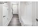 Hallway with neutral walls and wood floors offers a clean aesthetic with plenty of storage and hooks at 2549 Ellen Ave # 1017B, Charlotte, NC 28208