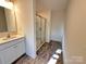 Bathroom showcasing a modern vanity, a glass-enclosed shower, and stylish tile flooring at 2623 Aubrey St, Monroe, NC 28110