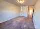 Bedroom featuring neutral walls, carpet flooring, overhead lighting, and a closet at 2623 Aubrey St, Monroe, NC 28110