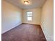 Carpeted bedroom with neutral walls and a window with natural light at 2623 Aubrey St, Monroe, NC 28110